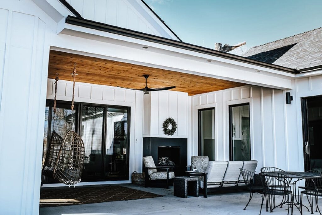 Modern outdoor patio with fireplace, sconces, ceiling fans and path lighting